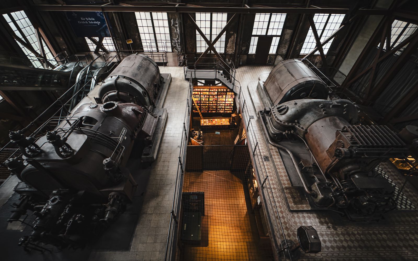 Overhead view of vintage industrial machinery inside a historic factory setting.