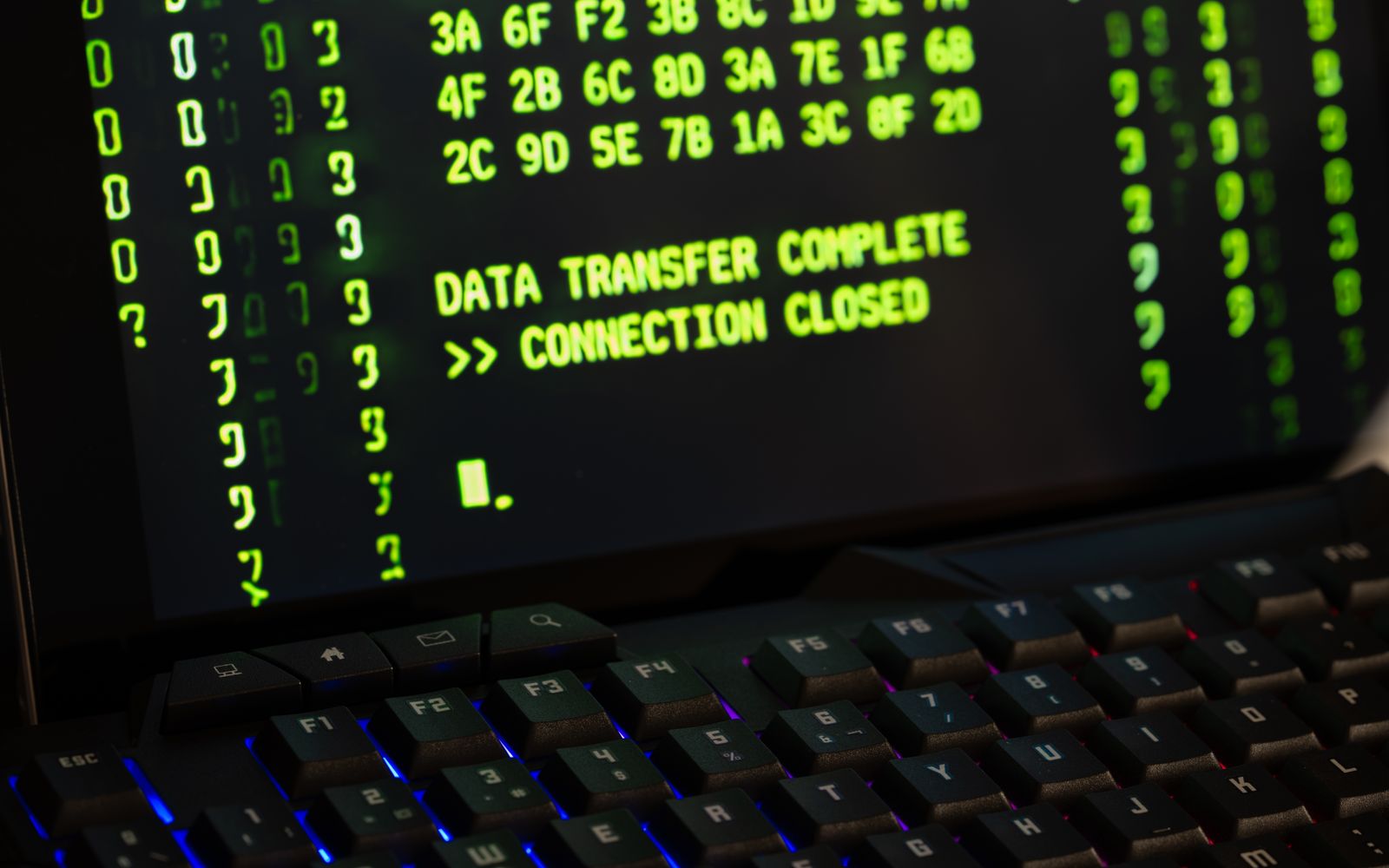 Data transfer complete message displayed on a computer monitor with a keyboard underneath.