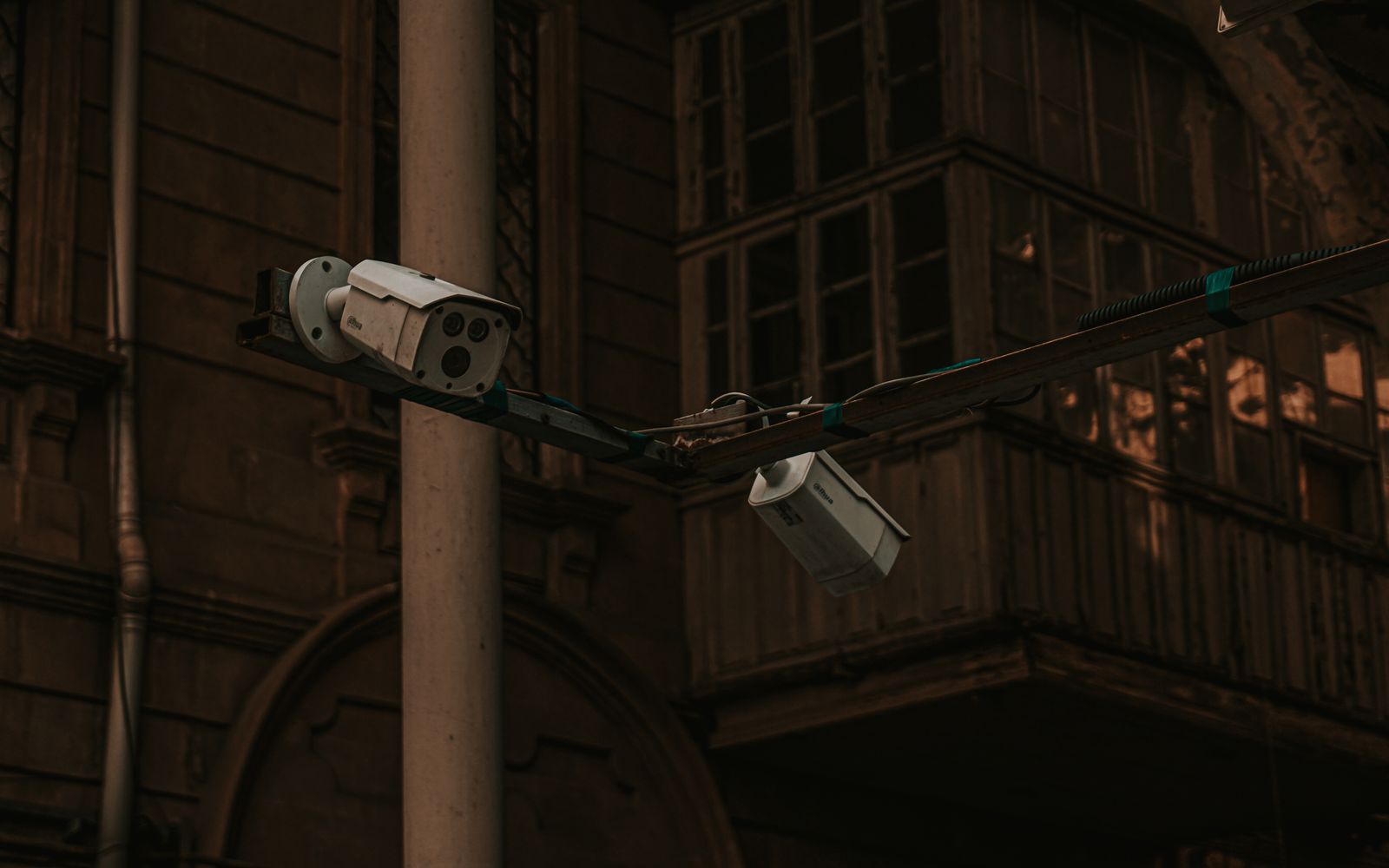 Street security cameras mounted on a pole in an urban environment, highlighting surveillance.
