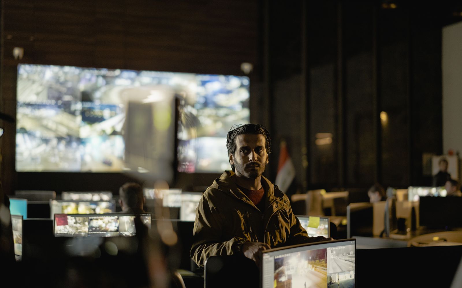 Modern security control room with a diverse team monitoring live surveillance feeds.