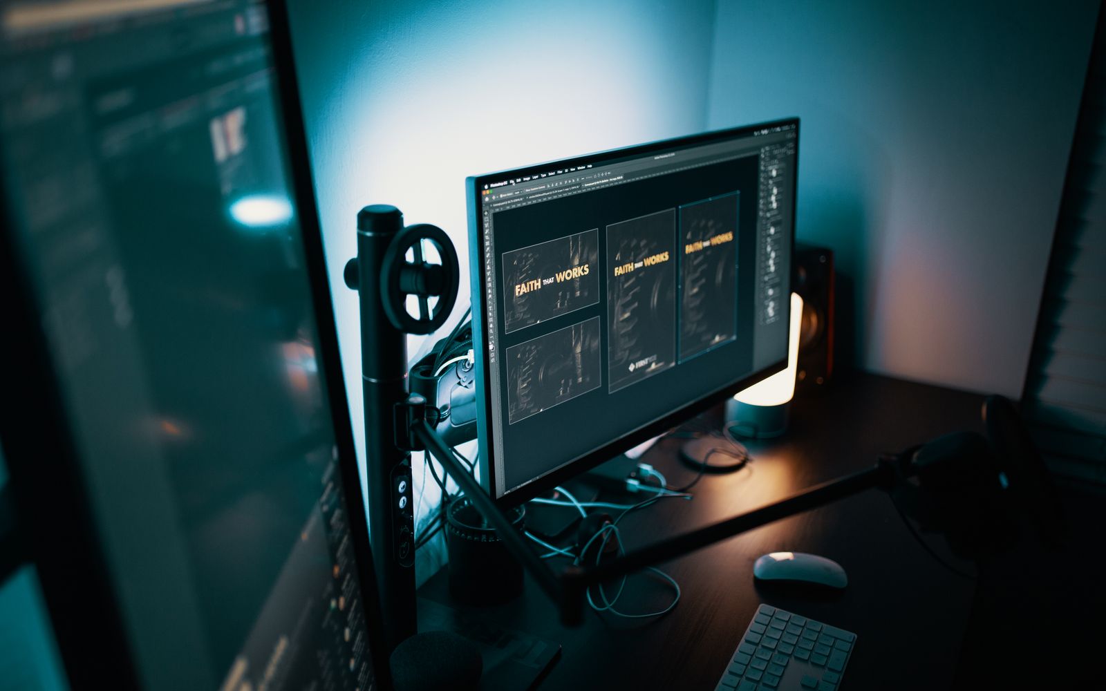 A stylish modern workspace with dual monitors displaying design software in a dimly lit room.