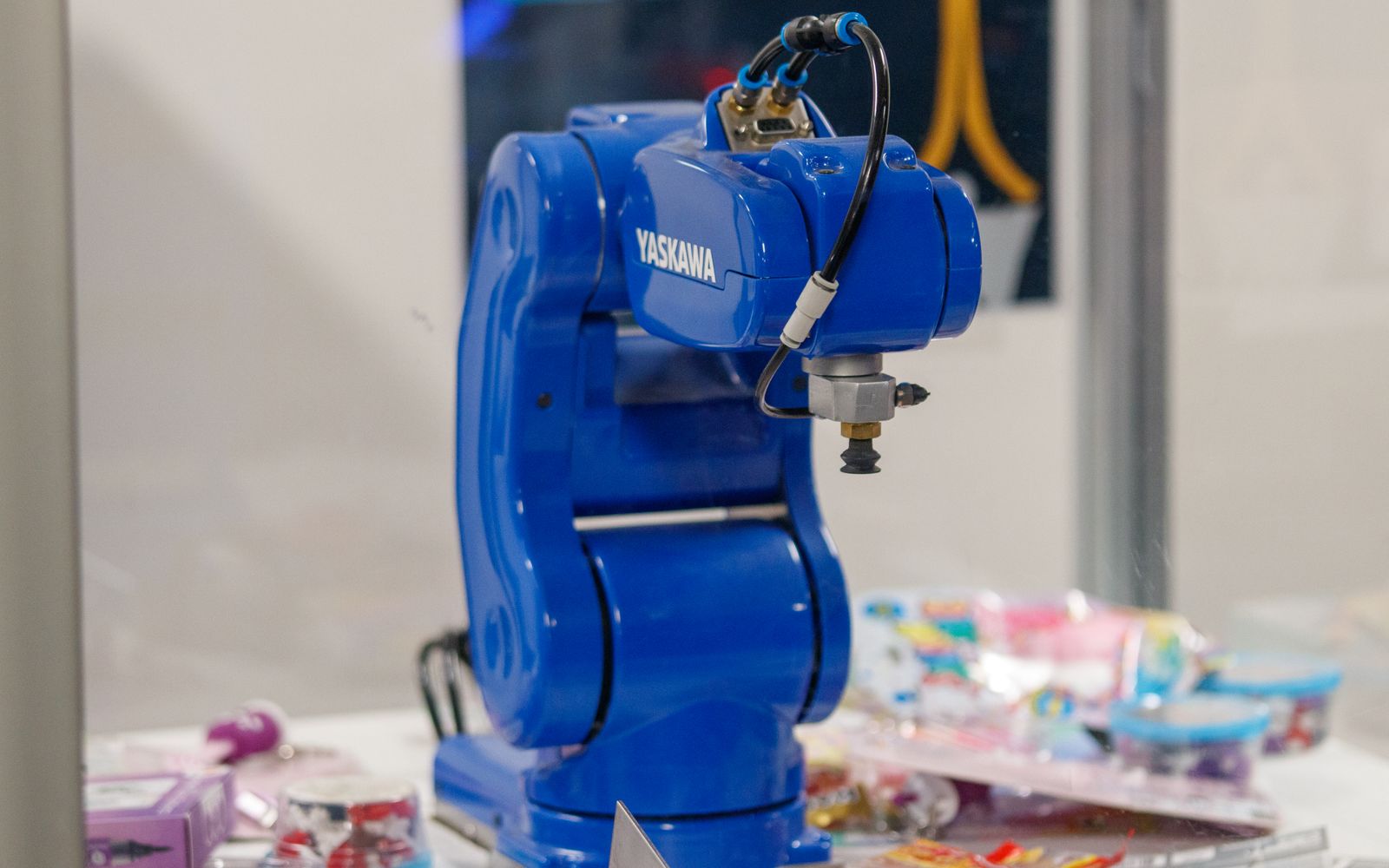 A blue Yaskawa industrial robot arm on display, showcasing advanced technology and robotics.